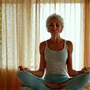 Adult performing gentle, sustainable exercise, perhaps yoga or stretching, with good form.